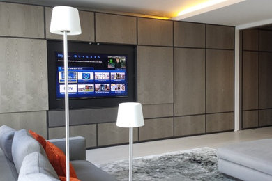 This is an example of a large contemporary living room in London with a concealed tv.