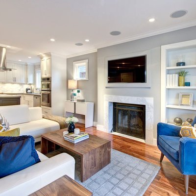 Living room - contemporary open concept medium tone wood floor living room idea in Vancouver with blue walls and a wall-mounted tv