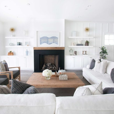Living room - coastal dark wood floor living room idea in Orange County with white walls and a standard fireplace