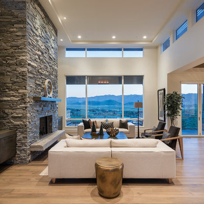 Living room - large contemporary open concept and formal medium tone wood floor living room idea in Salt Lake City with a standard fireplace, a stone fireplace, white walls and no tv