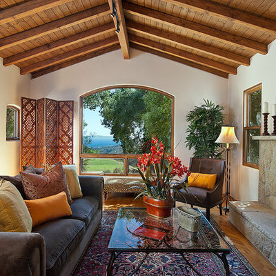 Inspiration for a rustic living room remodel in Santa Barbara with a stone fireplace