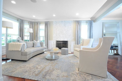 Example of a mid-sized trendy open concept medium tone wood floor living room design in New York with white walls, a standard fireplace, a stone fireplace and no tv