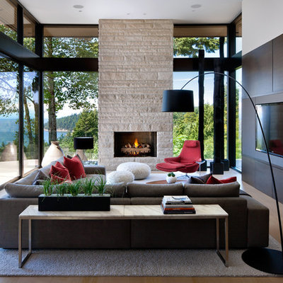 Inspiration for a large modern open concept beige floor and medium tone wood floor living room remodel in Vancouver with a media wall, a standard fireplace and a stone fireplace