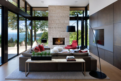 Inspiration for a large modern open concept beige floor and medium tone wood floor living room remodel in Vancouver with a media wall, a standard fireplace and a stone fireplace