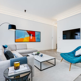 Design ideas for a scandi enclosed living room in London with white walls, light hardwood flooring, a wall mounted tv and grey floors.