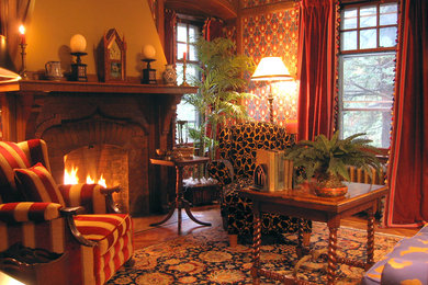 Example of a mid-sized classic formal and enclosed dark wood floor living room design in New York with blue walls, a standard fireplace, a brick fireplace and no tv
