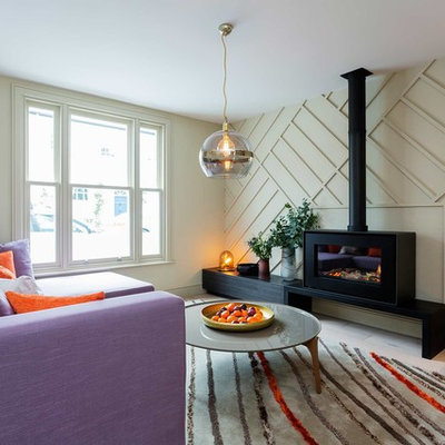 Example of a mid-sized trendy enclosed living room design in London with white walls and a ribbon fireplace