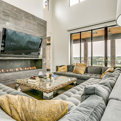 Trendy open concept living room photo in Dallas with gray walls, a wall-mounted tv and a ribbon fireplace