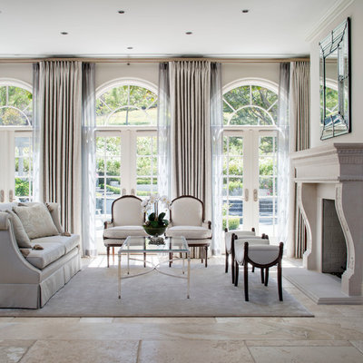 Example of a large french country formal and open concept ceramic tile living room design in Los Angeles with beige walls, a standard fireplace, a stone fireplace and no tv