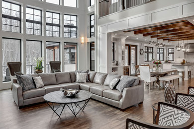 Huge transitional open concept dark wood floor and brown floor living room photo in Calgary with gray walls