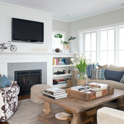 Mid-sized beach style formal and enclosed dark wood floor and brown floor living room photo in New York with gray walls, a wall-mounted tv, a standard fireplace and a tile fireplace