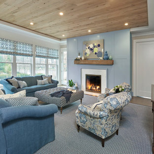 Living room - traditional medium tone wood floor and brown floor living room idea with gray walls and a stone fireplace