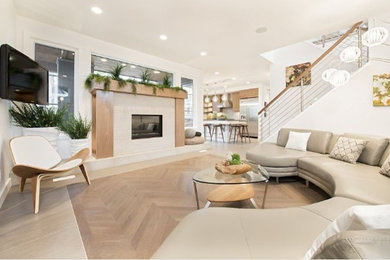 Mid-sized trendy formal and enclosed light wood floor and beige floor living room photo in Calgary with white walls, a standard fireplace, a tile fireplace and a wall-mounted tv