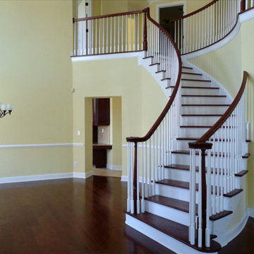 White painted and dark wood curving staircase