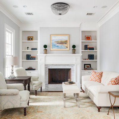 Mid-sized transitional formal and enclosed medium tone wood floor and brown floor living room photo in Houston with a standard fireplace, a stone fireplace, gray walls and no tv