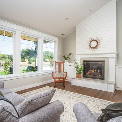 Inspiration for a large transitional open concept medium tone wood floor and brown floor living room remodel in Portland with gray walls, a standard fireplace, a tile fireplace and no tv