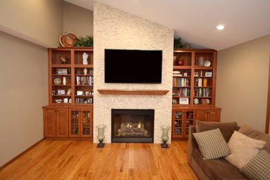 Mid-sized elegant open concept light wood floor living room library photo in Other with a standard fireplace, a tile fireplace, beige walls and a wall-mounted tv