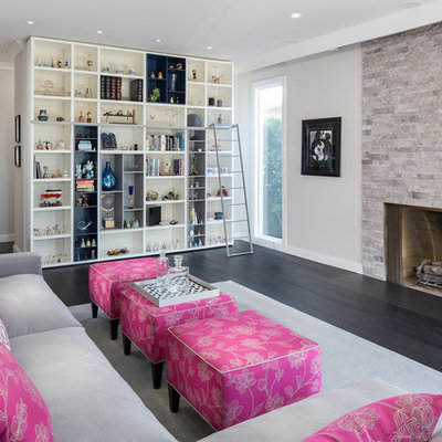Inspiration for a mid-sized contemporary enclosed dark wood floor and brown floor living room remodel in Los Angeles with beige walls, a standard fireplace, a stone fireplace and no tv