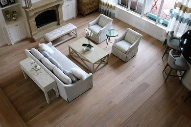 Photo of a large coastal living room in Miami with light hardwood flooring.