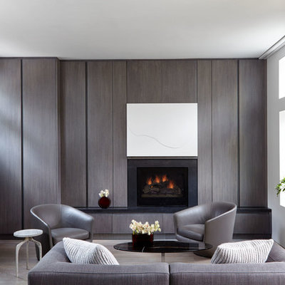 Mid-sized minimalist open concept brown floor and dark wood floor living room photo in New York with white walls, a standard fireplace, a stone fireplace and a concealed tv