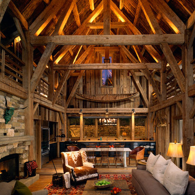 Example of a mountain style open concept living room design in Denver with a standard fireplace and a stone fireplace
