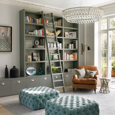 Example of a transitional light wood floor living room library design in London with gray walls