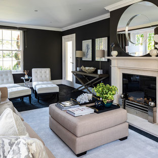 Inspiration for a classic formal living room in London with black walls, carpet and a standard fireplace.
