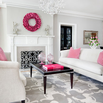 Inspiration for a transitional medium tone wood floor living room remodel in Minneapolis with gray walls, a standard fireplace and a stone fireplace