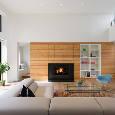 Inspiration for a large scandinavian open concept and formal light wood floor and brown floor living room remodel in Austin with white walls, a standard fireplace, a metal fireplace and a media wall