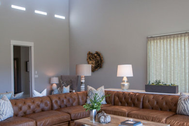 Living room - large farmhouse formal carpeted living room idea in Salt Lake City with gray walls, a two-sided fireplace, a stone fireplace and a media wall