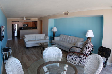 Example of a mid-sized open concept porcelain tile and brown floor living room design in Tampa with blue walls, no fireplace and a wall-mounted tv