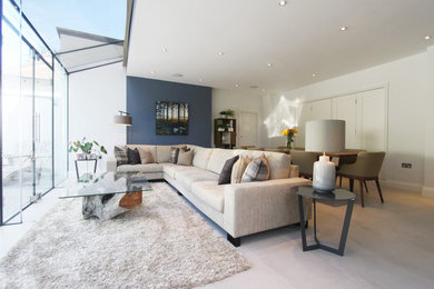 Inspiration for a medium sized contemporary living room in Surrey with white walls, no fireplace, no tv and beige floors.