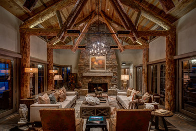 Inspiration for a rustic open concept dark wood floor and brown floor living room remodel in Salt Lake City with white walls, a standard fireplace and a stone fireplace