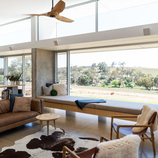 Mid-sized contemporary open concept living room in Other with white walls, concrete floors, no tv, grey floor and vaulted.