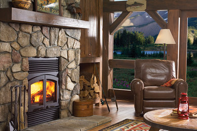 Example of a mid-sized mountain style formal and enclosed carpeted living room design in New York with beige walls, a standard fireplace, a stone fireplace and no tv