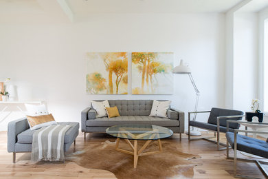 Inspiration for a large open concept light wood floor living room remodel in Toronto with white walls