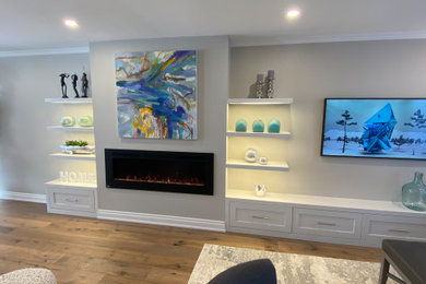 Inspiration for a mid-sized contemporary open concept light wood floor living room remodel in Toronto with a music area, gray walls, a standard fireplace and a media wall