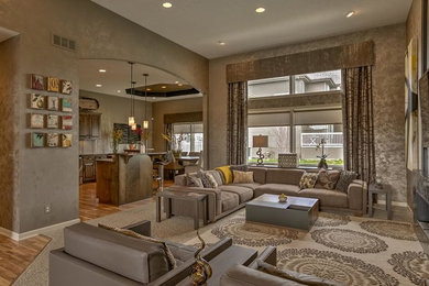 Large contemporary open plan living room in Omaha with brown walls, medium hardwood flooring, a ribbon fireplace, a concrete fireplace surround, a built-in media unit and brown floors.