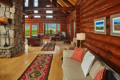 Mid-sized mountain style open concept living room photo in Other with a two-sided fireplace and a stone fireplace