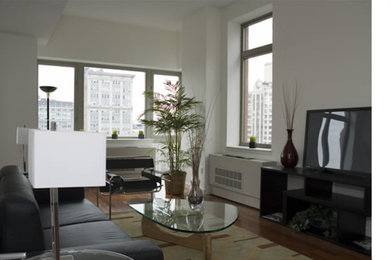 Mid-sized trendy open concept medium tone wood floor living room photo in New York with white walls and a tv stand