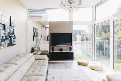 Inspiration for a contemporary living room in Other with beige walls and a wall mounted tv.