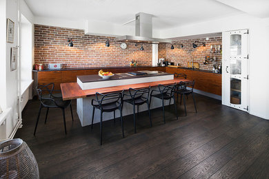 Photo of a contemporary dining room in Stockholm with dark hardwood flooring.