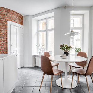 Idéer för ett mellanstort minimalistiskt kök med matplats, med vita väggar och grått golv