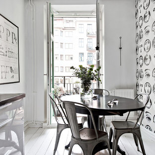 Minimalistisk inredning av en mellanstor matplats, med grå väggar, målat trägolv och vitt golv