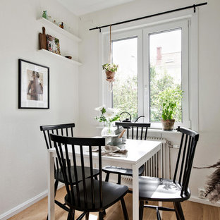 Inredning av ett minimalistiskt kök med matplats, med vita väggar, mellanmörkt trägolv och beiget golv