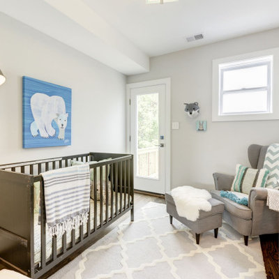 Inspiration for a transitional gender-neutral medium tone wood floor and brown floor nursery remodel in DC Metro with white walls