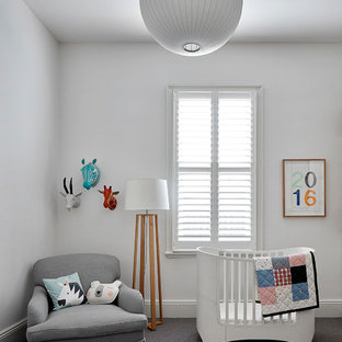 This is an example of a large contemporary gender-neutral nursery in Melbourne with white walls, carpet and grey floor.