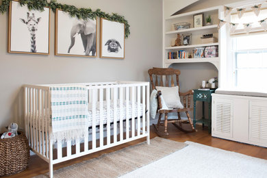 Inspiration for a transitional gender-neutral medium tone wood floor nursery remodel in Cedar Rapids with gray walls