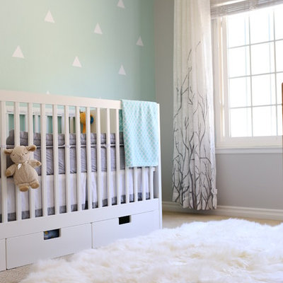 Example of a transitional gender-neutral carpeted and beige floor nursery design in San Diego with blue walls