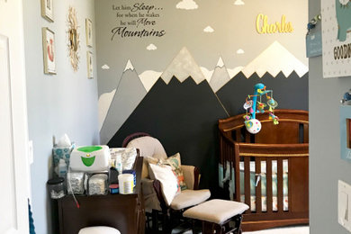 Nursery - mid-sized modern boy carpeted and beige floor nursery idea in Orlando with gray walls